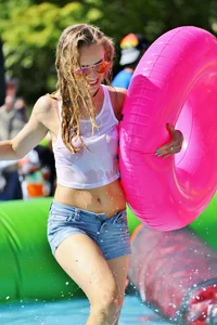Tubing hottie in shorts and a wet white shirt