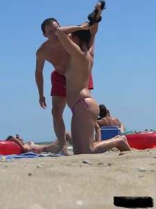 Purple thong topless lady on the beach gets oiled up by her husband