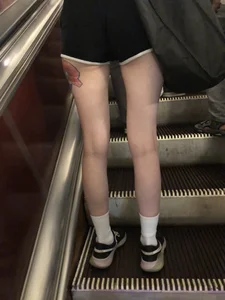 A Tall And Slim Candid Girl in Spandex Shorts in a Hoodie Top, With Tattoos on Her Long Legs Subway Creepshots