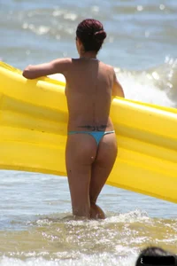 Blue thong lady in the water with a float