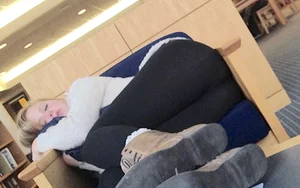 Girl in Leggings Asleep in an Armchair at the Library Creepshot