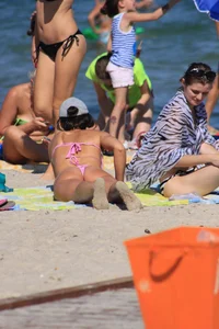 Sexy milf in pink thong bikini on the beach