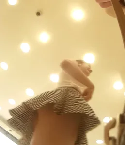 Skinny girl in a skirt low angle candid vid at the store