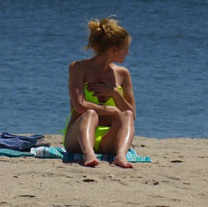 Sexy ass blonde milf on the beach in a thong with cameltoe and bending over