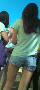 Skinny girl with purple hair in denim shorts