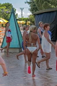 Big boobed blonde milf dancing by the pool in a bikini