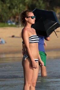Skinny sexy blonde in little striped bikini in the water