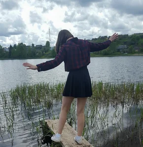 Cute Girl in a Skirt with Skinny Legs by the Lake Candid
