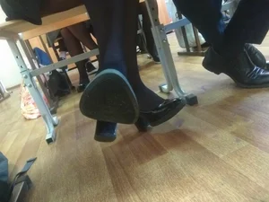 Crossed Feet in Shoes on High Heels And Black Pantyhose Under Desk Creepshot