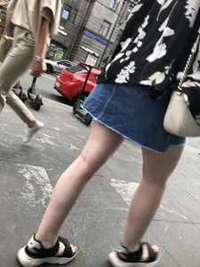 Hot pale legs of a candid girl crossing the street