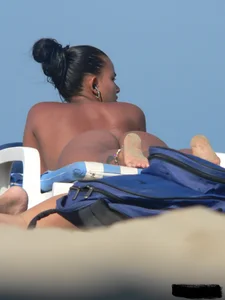 Hot ass topless beach girl with great tits lets her little brother oil up her ass in thong bikini