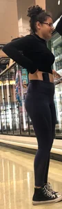 Girl with glasses shopping in leggings showing her VPL
