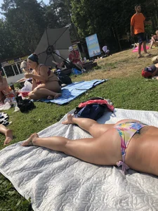 Female Legs and Ass in a Swimsuit on the Grass in a Park