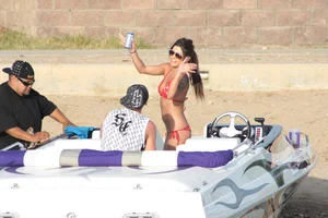Brunette on a boat in red thong bikini with a tight little ass