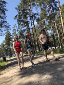Young Girl in a One-Piece Swimsuit Walking on a Forest Road Photo Gallery