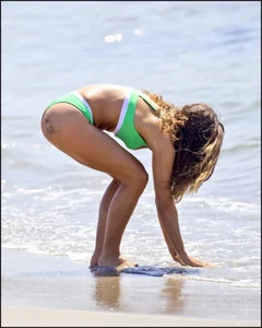 Super hot beach babe with a perfect body in a green thong bikini