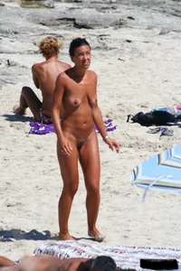 Smoking milf at a nude beach with a hairy pussy