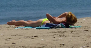 Sexy ass blonde milf on the beach in a thong with cameltoe and bending over