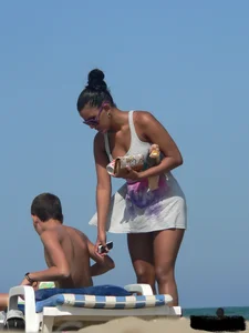 Hot ass topless beach girl with great tits lets her little brother oil up her ass in thong bikini