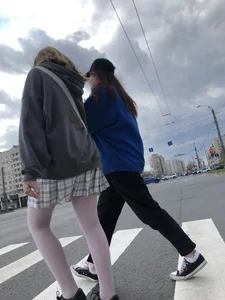 Candid teen girl wearing a skirt and white pantyhose crossing the street creepshots