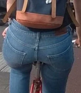Blonde girl on a bike with a big tight ass in tight jeans