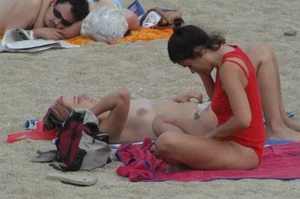Topless girls on a beach in Barcelona