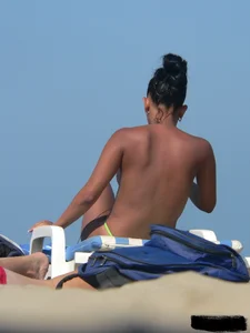 Hot ass topless beach girl with great tits lets her little brother oil up her ass in thong bikini