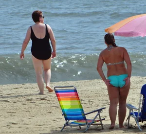 Thick beach girl in a teal bikini