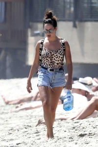 Ashley Tisdale in cheetah print swimsuit on the beach in Malibu