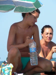 Bunch of sexy babes on the beach topless and in thong bikinis