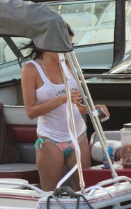 Bikini babe on a boat with a wet see through white shirt showing her tits