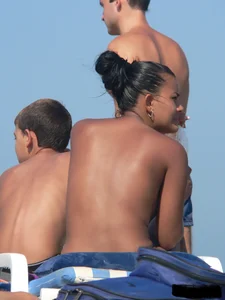 Hot ass topless beach girl with great tits lets her little brother oil up her ass in thong bikini