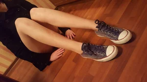 Skinny Legs of a Teen Girl Sitting on the Floor