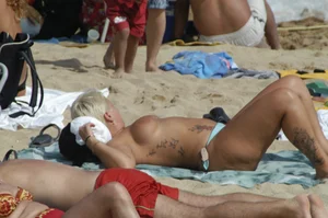 Topless girls on a beach in Barcelona