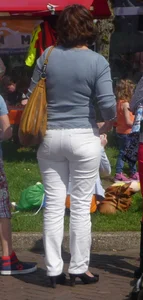 Booties of street candid girls wearing tight jeans