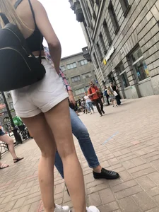 Hot Candid Girl in a Top, Shorts and Sneakers Skinny Legs Closeup Creepshots Gallery on the City Street