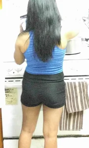 Asian girlfriend doing dishes in spandex shorts