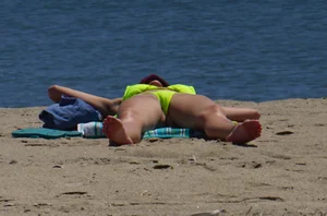 Sexy ass blonde milf on the beach in a thong with cameltoe and bending over
