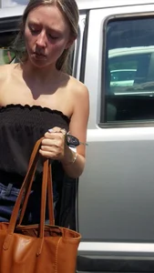 Pretty babe with small boobs in black top getting out of her car