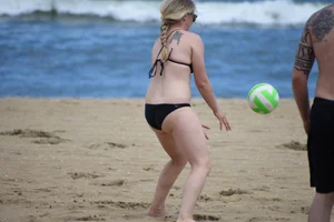 Chunky blonde in a black bikini on the beach