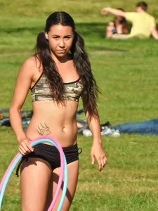 Fit brunette posing in the park. With hoops! [011]