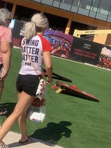 Bunch of girls in various outfits at a Cardinals baseball game