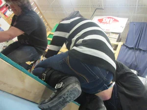 Skinny Girl in Jeans Standing on Her Knees at a Workshop Creepshot