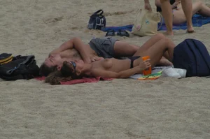 Topless girls on a beach in Barcelona