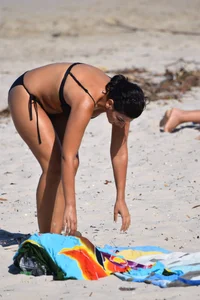 Thick mature brunette bikini lady on the beach with a nice body