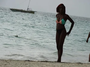 Candid black family, milf and teens on the beach in bikinis