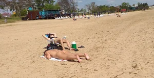 Girl laying out getting sun in a white thong bikini