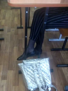 Teen College Student's Crossed Legs in Pants, Black Pantyhose And Flats
