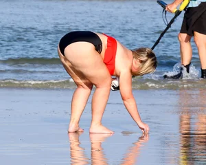 Thick BBW blonde lady in a bikini at the beach
