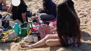 Beautiful Teen with Miniskirt resting on the beach